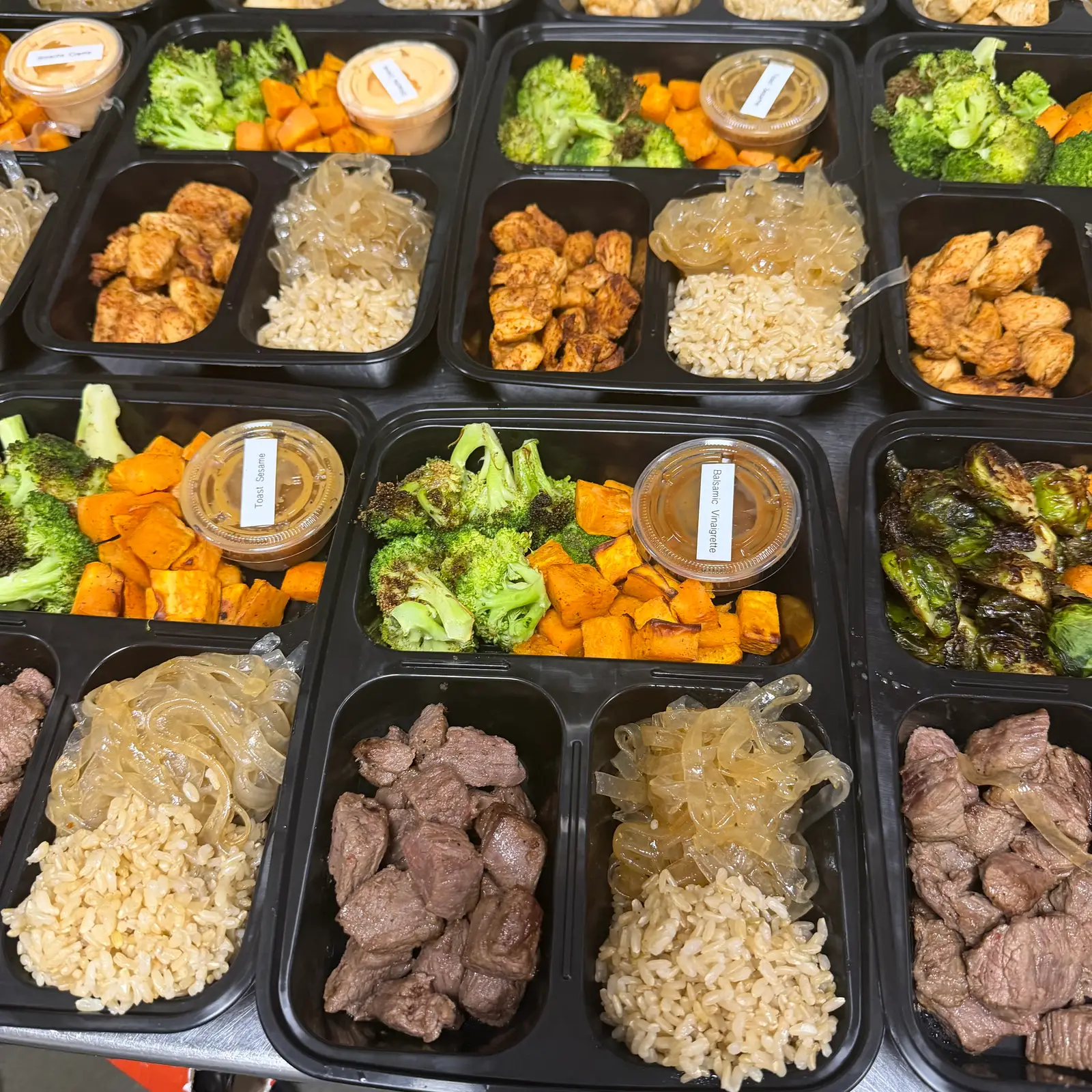 Freshly prepared Brack's office lunch bowls with grilled steak, brown rice, roasted broccoli, and sweet potatoes